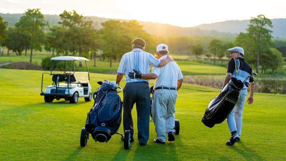 Group of men golfing in the evening